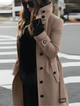 Women's belted long coat with high collar and button front