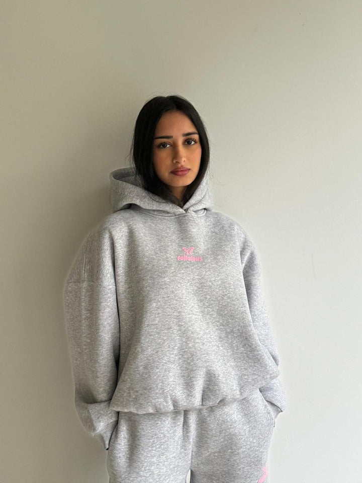 Women's gray hooded sweatshirt with pink chest logo