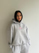 Women's gray hooded sweatshirt with pink chest logo