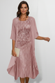 Woman wearing a beige sequin midi dress with attached cape sleeve overlay