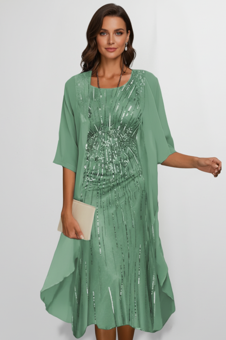 Woman wearing a beige sequin midi dress with attached cape sleeve overlay