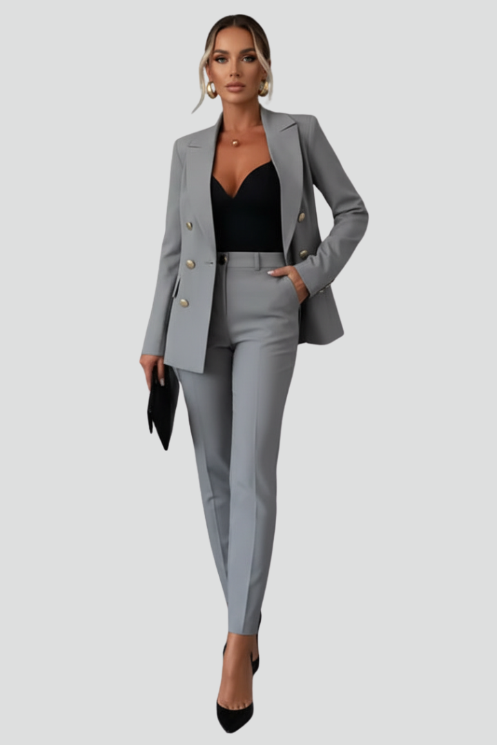 Woman wearing a black double-breasted blazer suit set with straight leg trousers