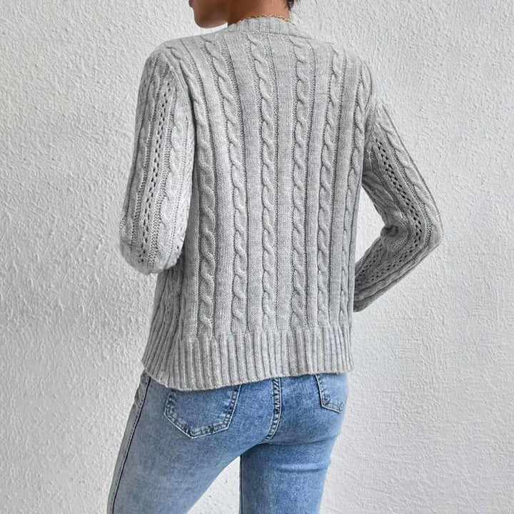Women's cable knit button front cardigan with long sleeves and crew neckline