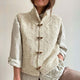 Women's white textured sleeveless cardigan vest with mock neck and button front