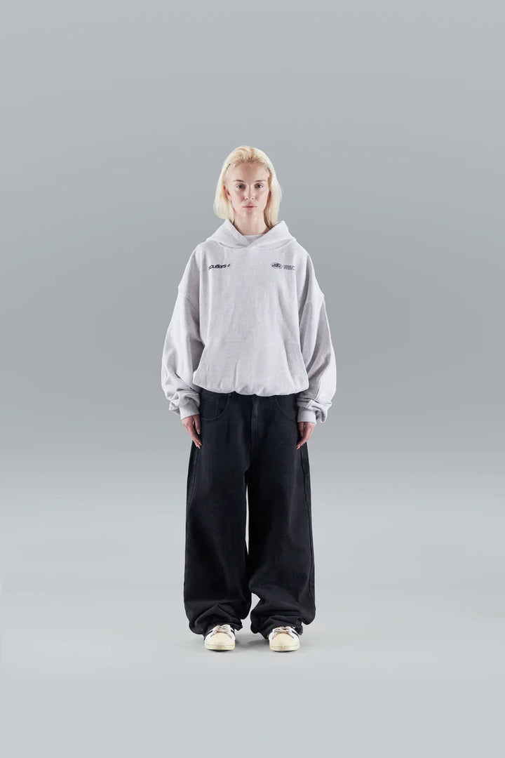 Woman wearing a relaxed hooded sweatshirt with a front pouch pocket
