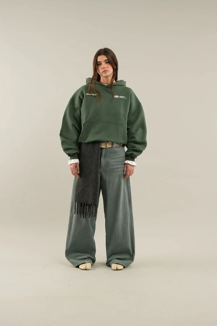 Woman wearing a relaxed hooded sweatshirt with a front pouch pocket