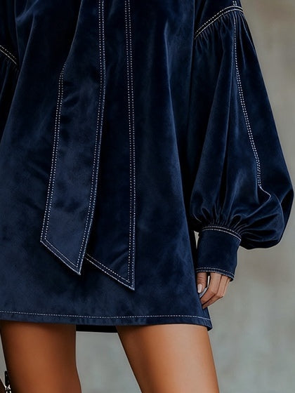 Women's navy velvet mini dress with bow neckline and long balloon sleeves
