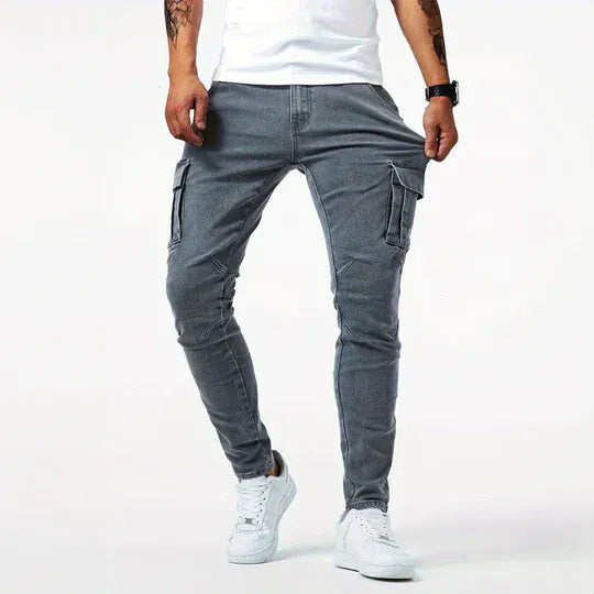 Men's tapered cargo jeans with multiple thigh pockets and panel detailing
