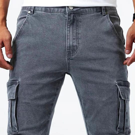Men's tapered cargo jeans with multiple thigh pockets and panel detailing
