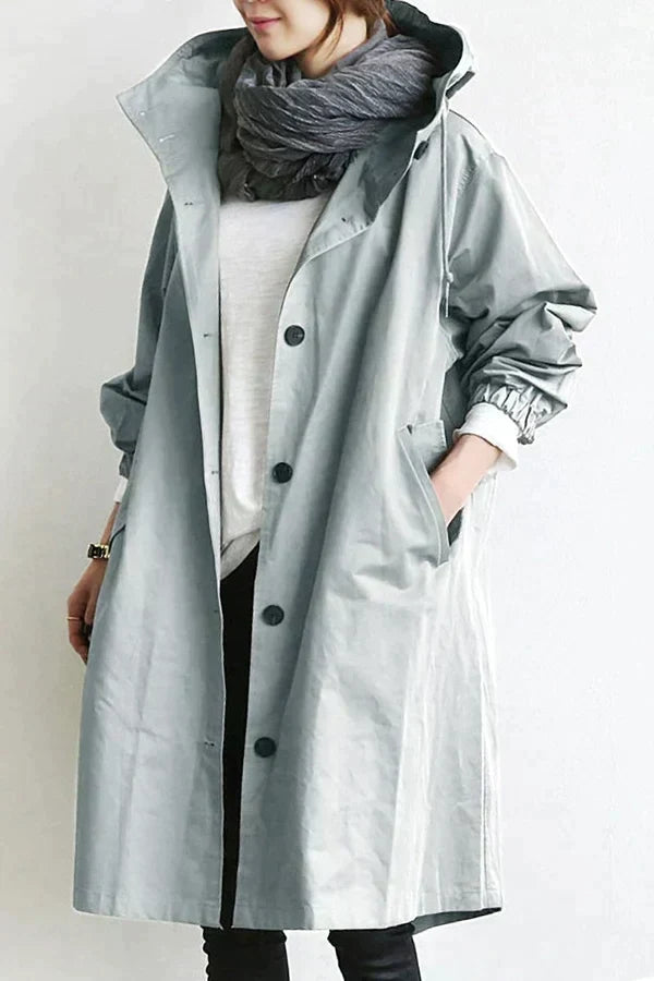 Women's oversized hooded mid-length trench coat with button front and side pockets
