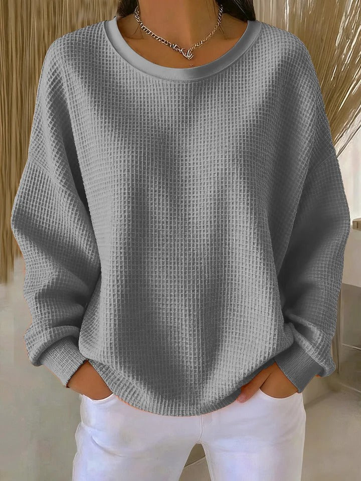 Women's textured crew neck sweater with long sleeves and ribbed cuffs