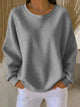 Women's textured crew neck sweater with long sleeves and ribbed cuffs