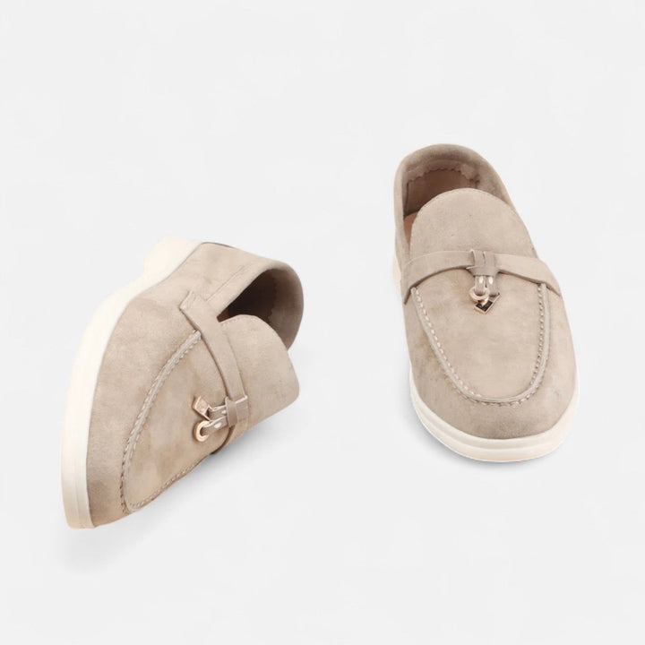 Men's textured slip-on loafers with flat soles, stitched apron detail and decorative toggle trim