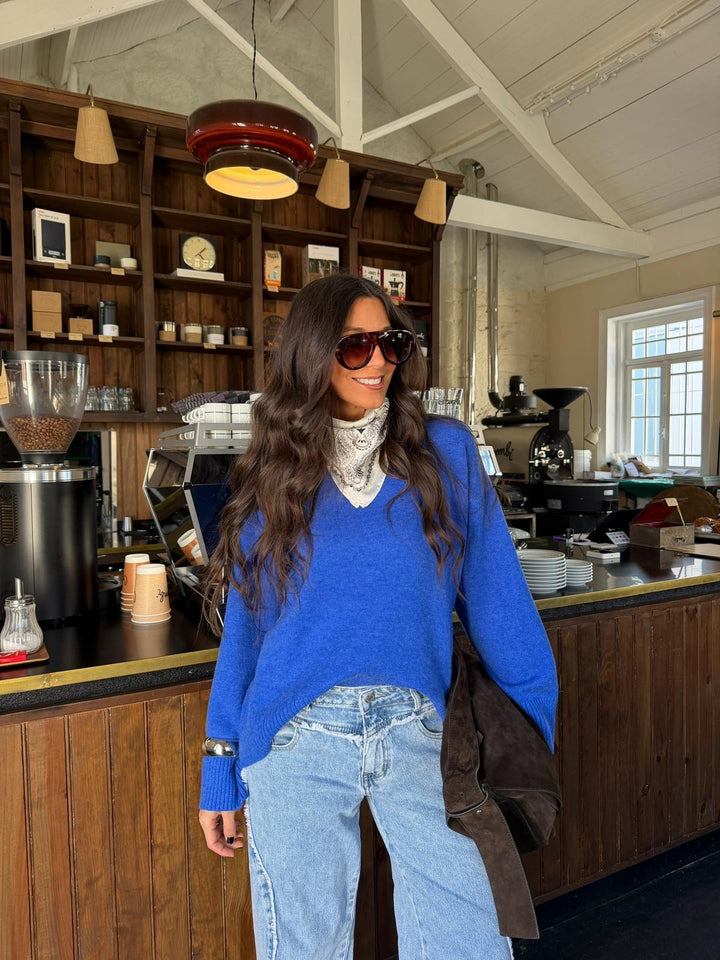 Women's blue long-sleeve V-neck knit sweater with ribbed trims