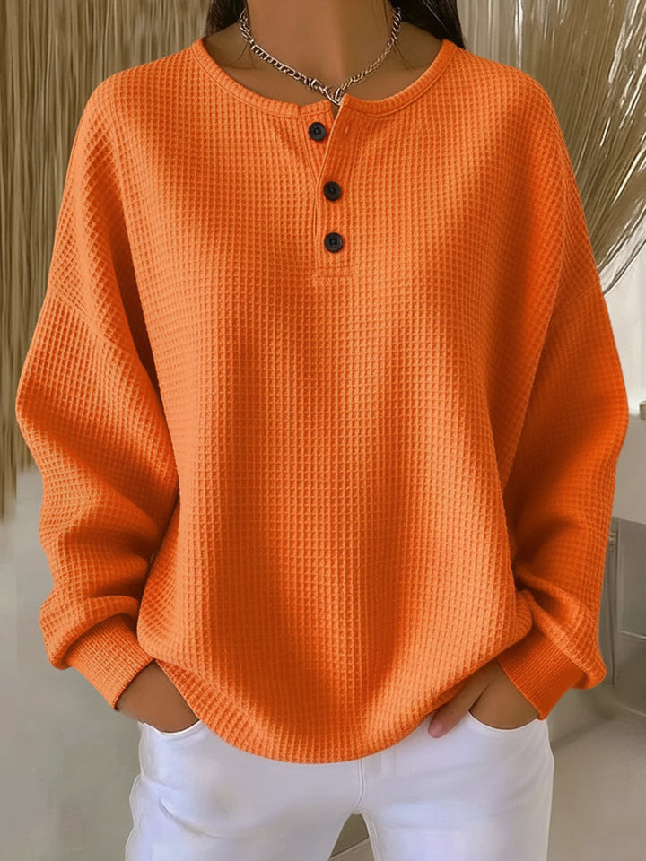 Women's waffle knit Henley top with long sleeves and button placket