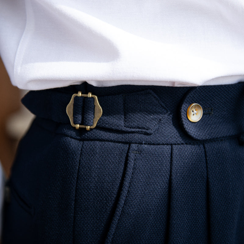 Pleated trousers with side waist tabs, belt loops and cuffed hems