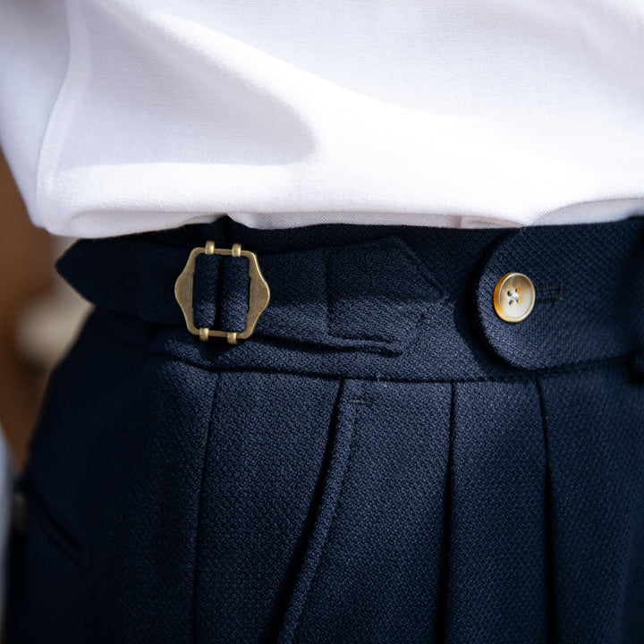 Pleated trousers with side waist tabs, belt loops and cuffed hems