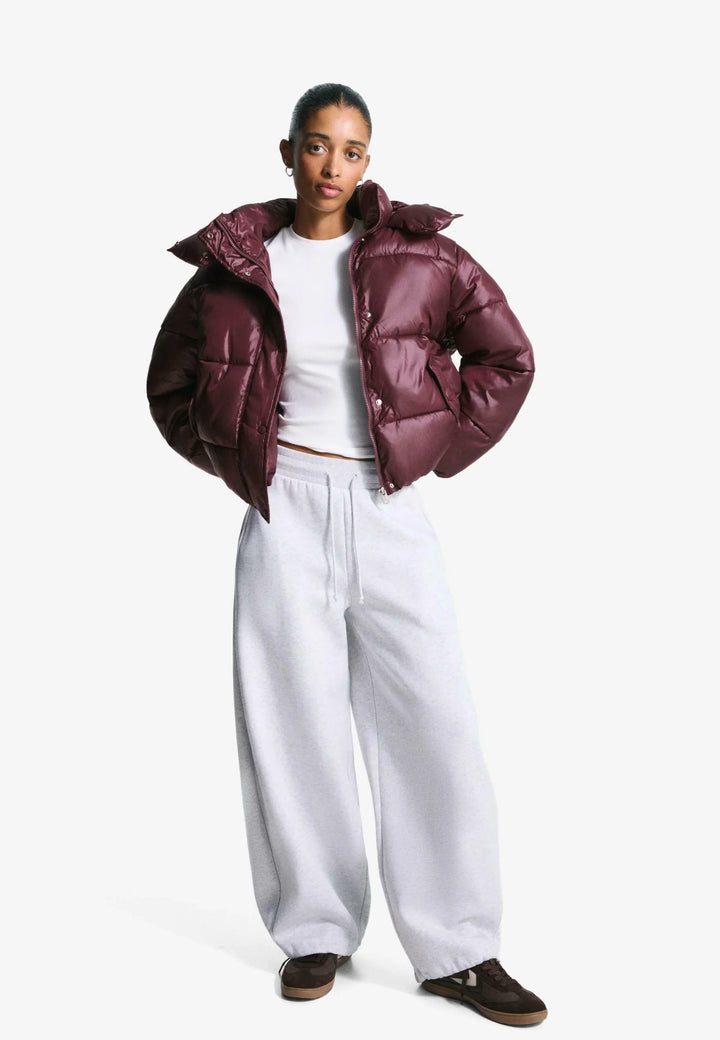 Women's burgundy hooded puffer jacket with quilted panels