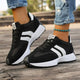 Women's black and white lace-up sneaker with striped side detail