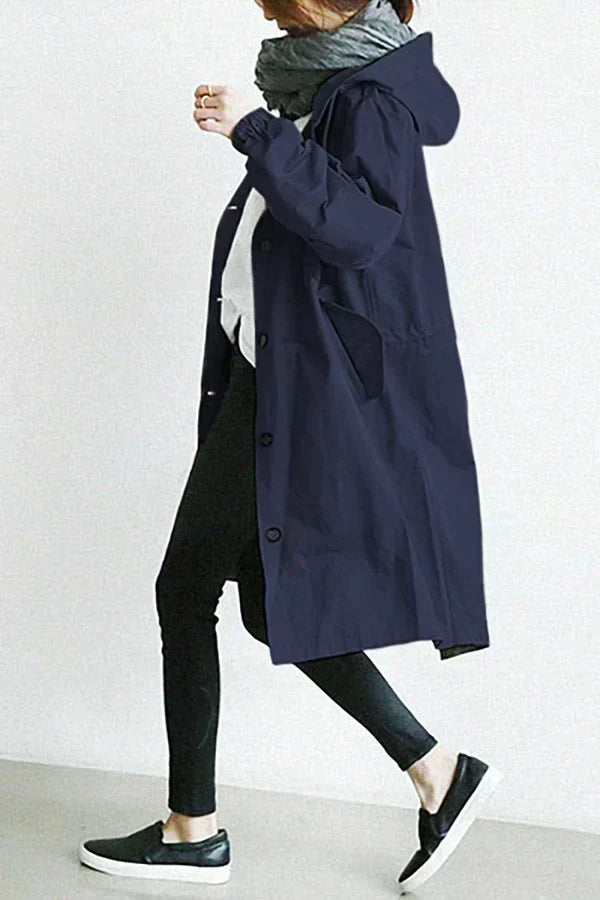 Women's oversized hooded mid-length trench coat with button front and side pockets