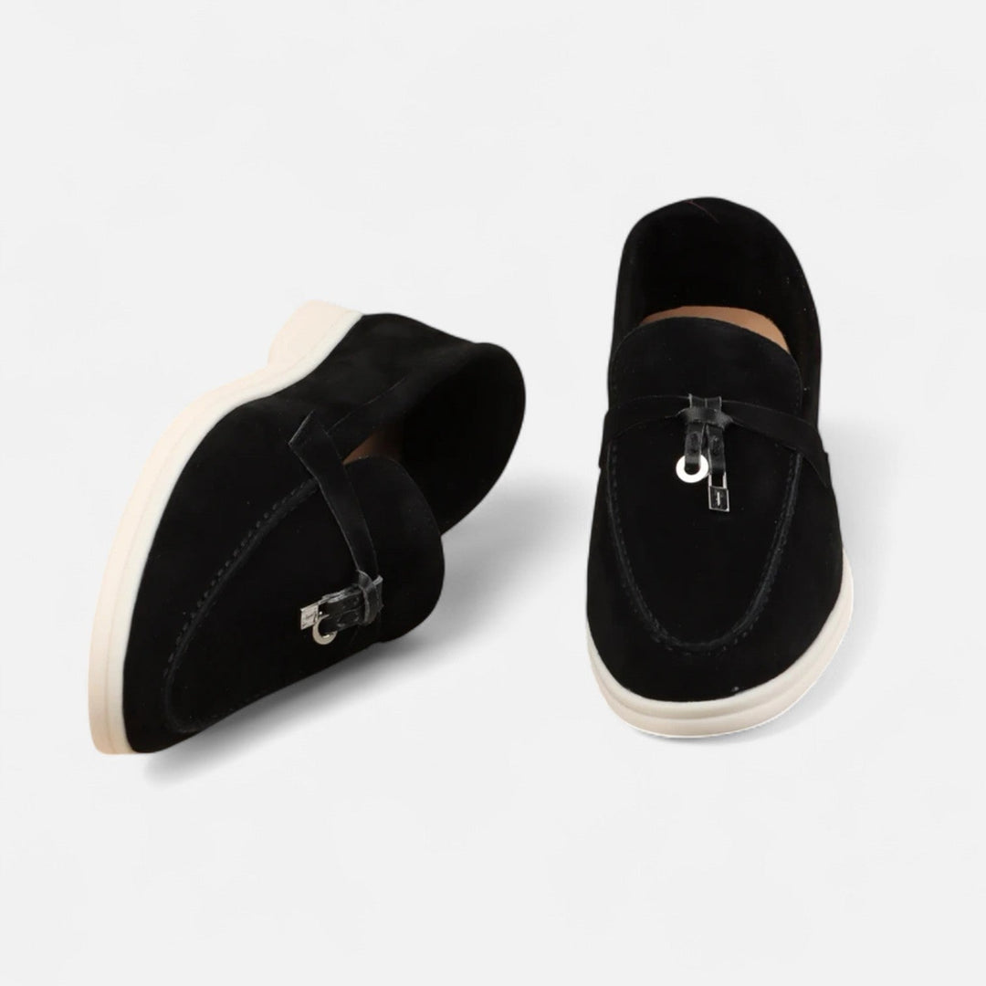 Men's textured slip-on loafers with flat soles, stitched apron detail and decorative toggle trim