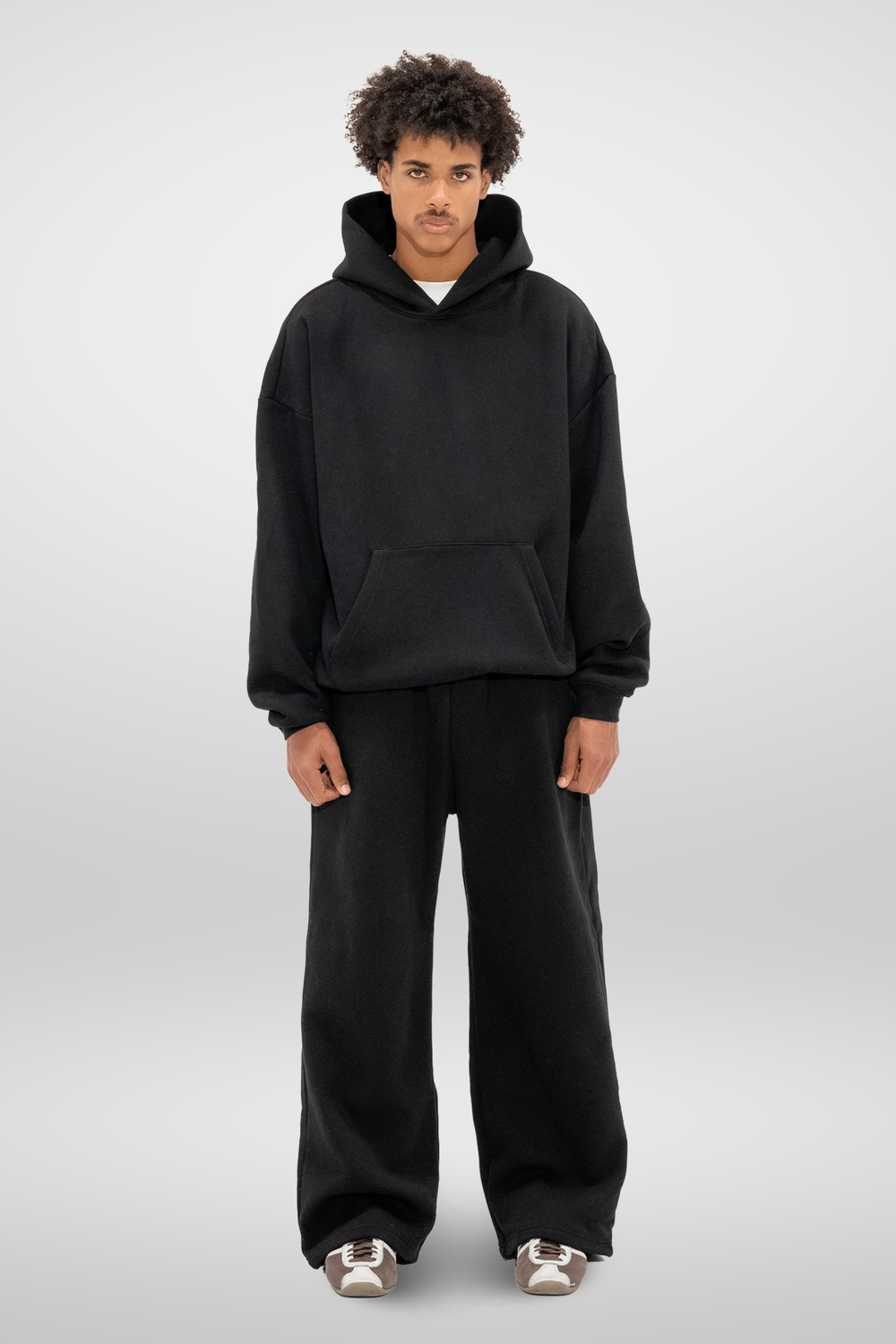 Man wearing black wide-leg sweatpants with an elastic waistband and side pockets