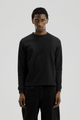 Black long sleeve crew neck top with ribbed cuffs and hem