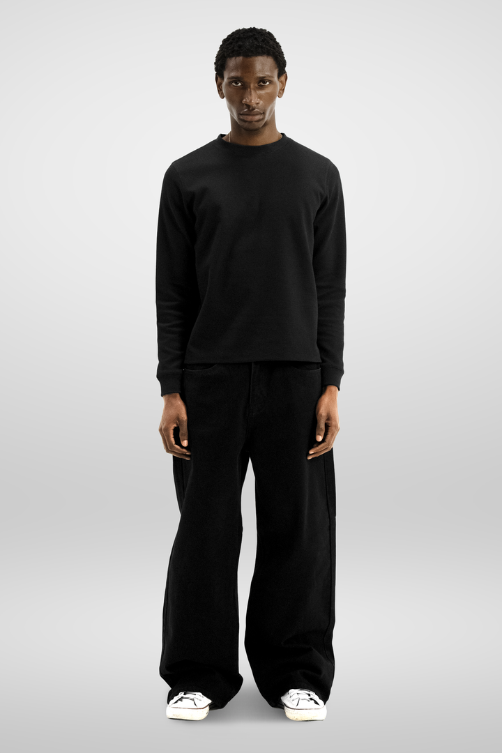 Black long sleeve crew neck top with ribbed cuffs and hem
