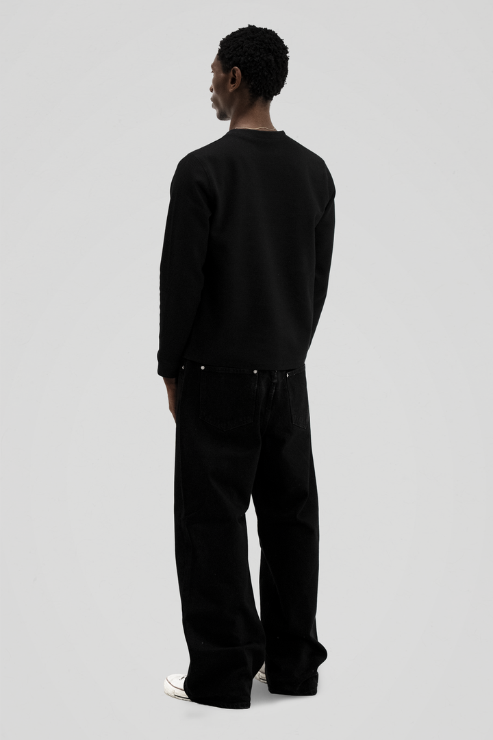 Black long sleeve crew neck top with ribbed cuffs and hem