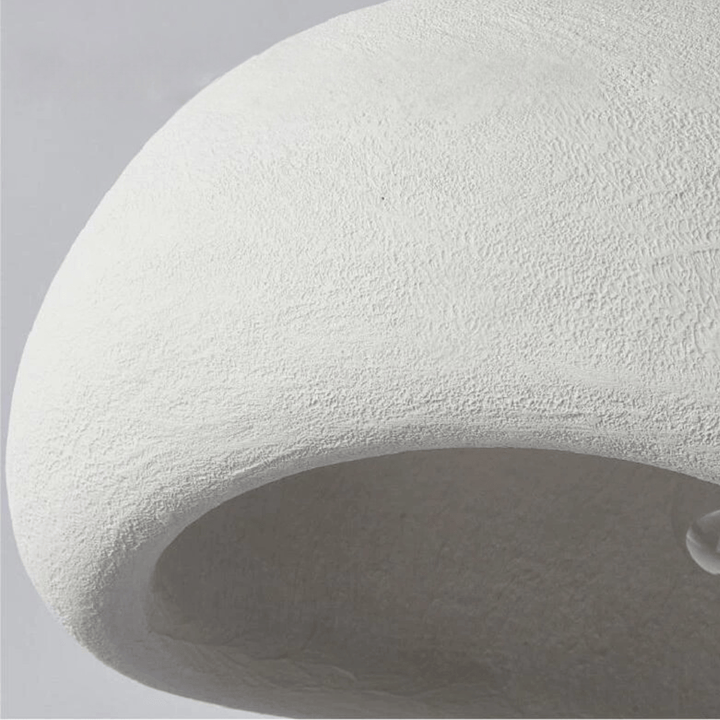 Dome pendant light with warm gold-toned interior and visible bulb