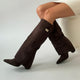 Women's black faux leather over-the-knee boots with buckle detail