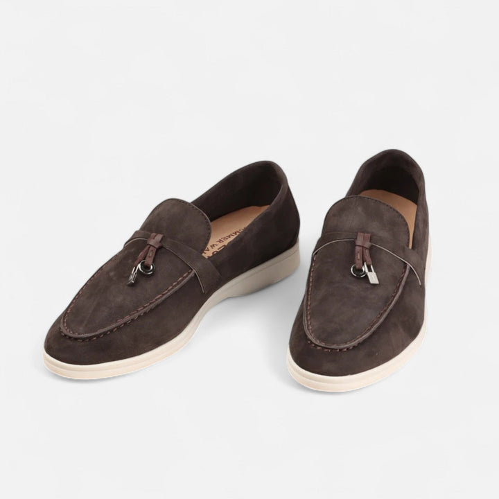 Men's textured slip-on loafers with flat soles, stitched apron detail and decorative toggle trim