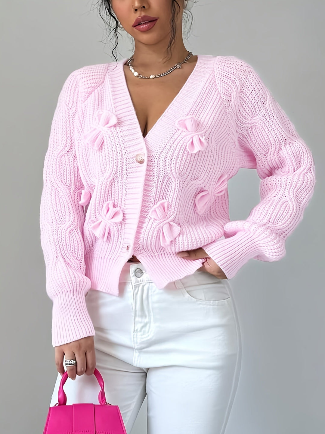 Women's ribbed V-neck cardigan with bow details and button front