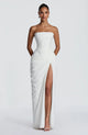 Woman wearing strapless ruched maxi dress with high side slit in yellow and navy versions
