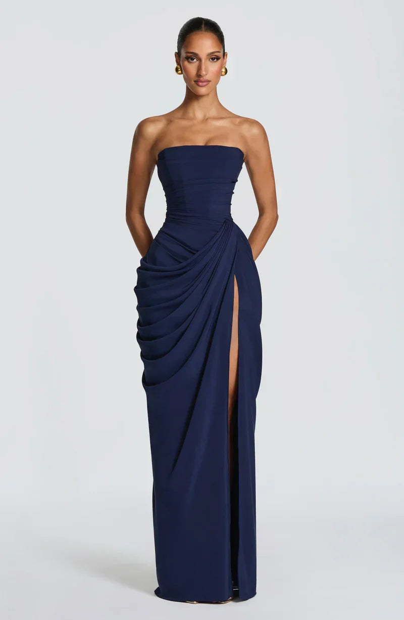 Woman wearing strapless ruched maxi dress with high side slit in yellow and navy versions