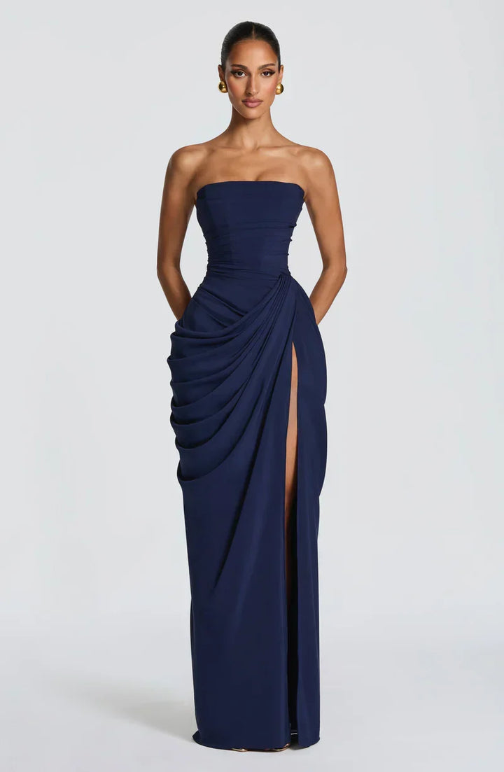Woman wearing strapless ruched maxi dress with high side slit in yellow and navy versions