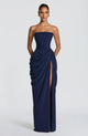 Woman wearing strapless ruched maxi dress with high side slit in yellow and navy versions