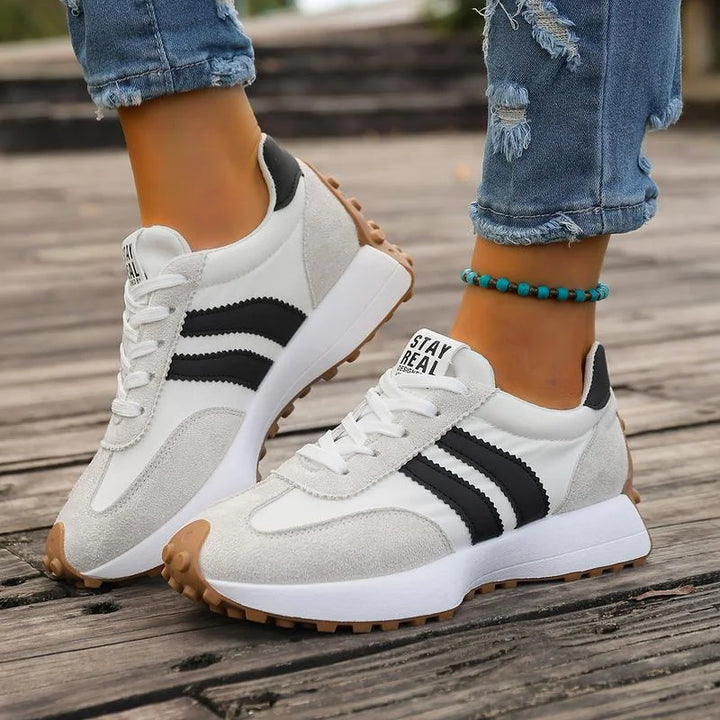 Women's black and white lace-up sneaker with striped side detail