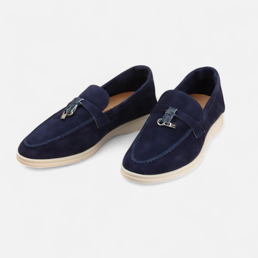 Men's textured slip-on loafers with flat soles, stitched apron detail and decorative toggle trim