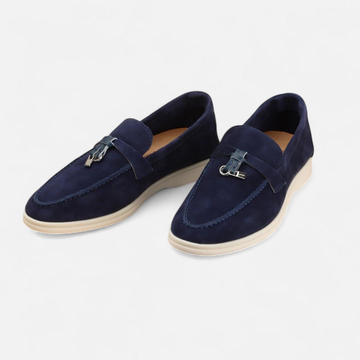 Men's textured slip-on loafers with flat soles, stitched apron detail and decorative toggle trim