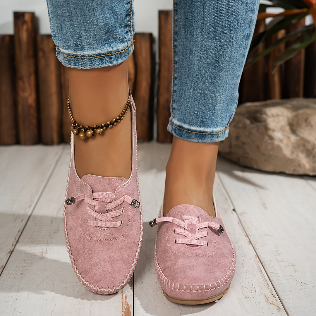 Women's low-profile lace-up moccasin shoes with stitched trim and flat textured soles