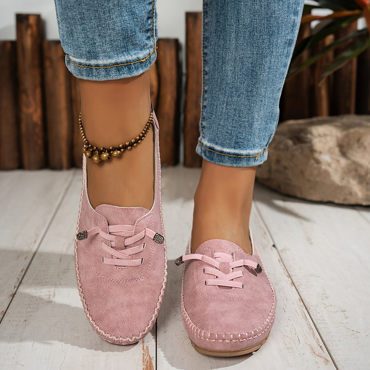 Women's low-profile lace-up moccasin shoes with stitched trim and flat textured soles