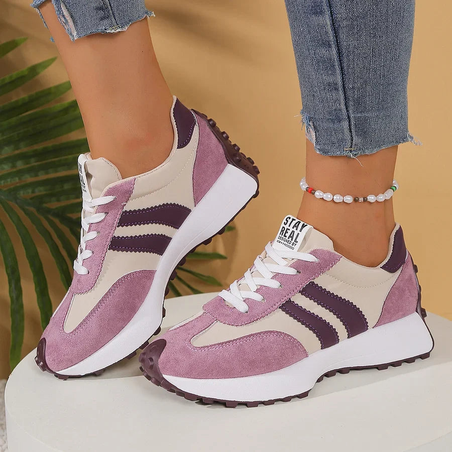Women's black and white lace-up sneaker with striped side detail