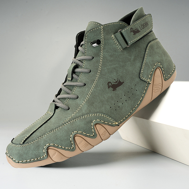 Unisex lace-up ankle boot with rounded toe, side strap detail and wavy textured sole