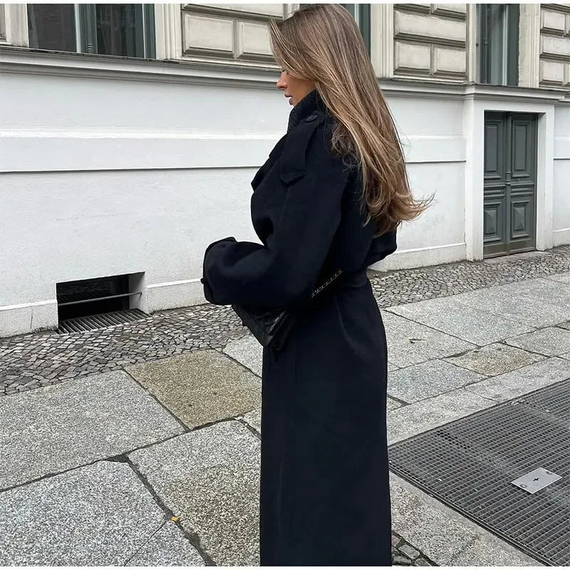 Woman wearing a black double-breasted long trench coat