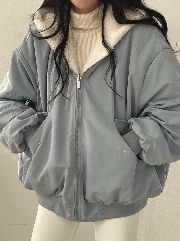 Women's reversible hooded jacket shown in black and blue with plush lining