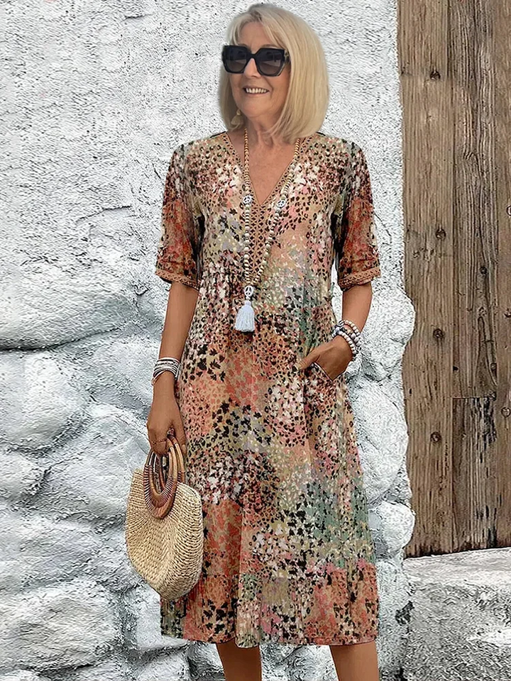 Women's vibrant mosaic pattern midi dress with V-neck and three-quarter sleeves, shown in red and teal