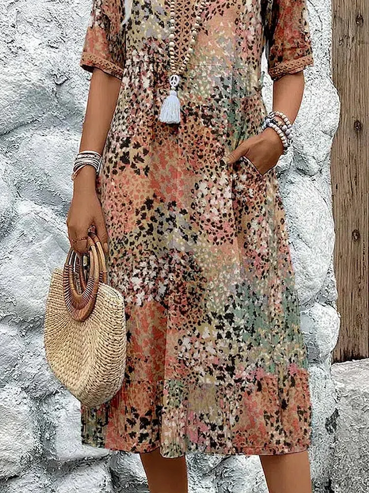 Women's vibrant mosaic pattern midi dress with V-neck and three-quarter sleeves, shown in red and teal