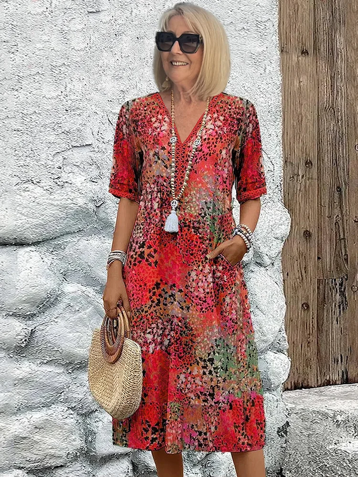 Women's vibrant mosaic pattern midi dress with V-neck and three-quarter sleeves, shown in red and teal