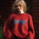 Women's red jumper with blue dragonfly graphic